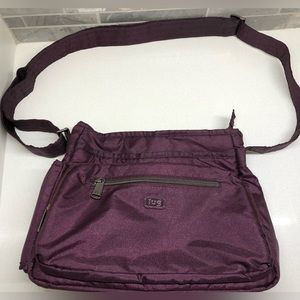Lug Shimmy Crossbody Bag. Plum exterior , pink interior.